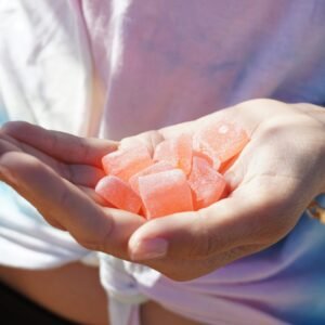 person holding orange medicine tablets